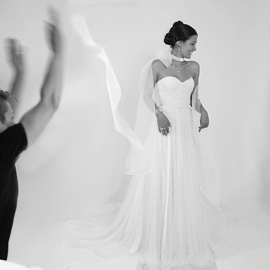 behind the scene wedding dress photoshoot model laughing
