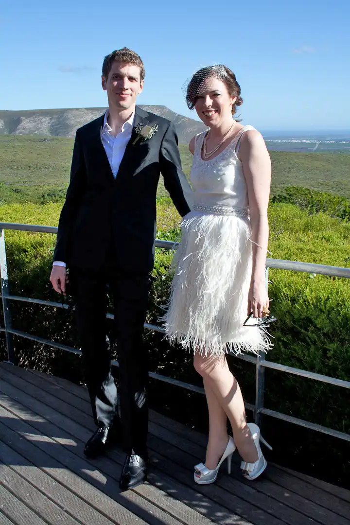 real couple wedding outdoors feather skirt and beaded top 50s style wedding dress gown
