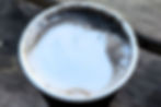 Close-up of Tokyo Bagel’s black sesame latte with creamy milk froth and black sesame swirl.