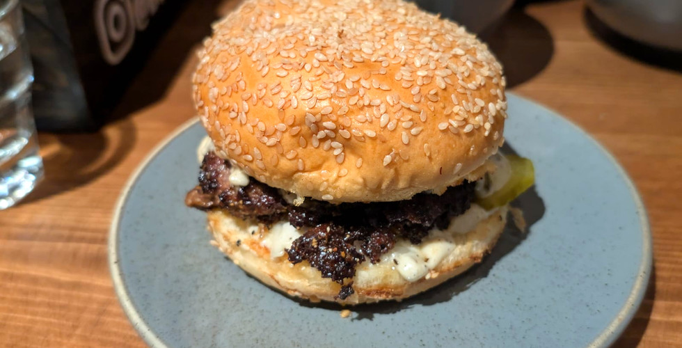 A close-up of Buk's truffle burger, featuring crispy smash patties, truffle mayo – a must-try for Camden Burgers lovers.