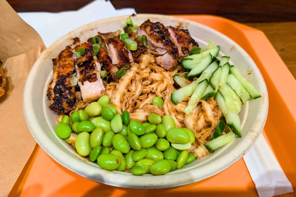 Close-up of sesame and soy chicken thigh noodles with edamame beans and cucumber at Kung Fu Mama.