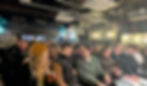 A sold out crowd sitting down to watch comedy at the top secret comedy club in London