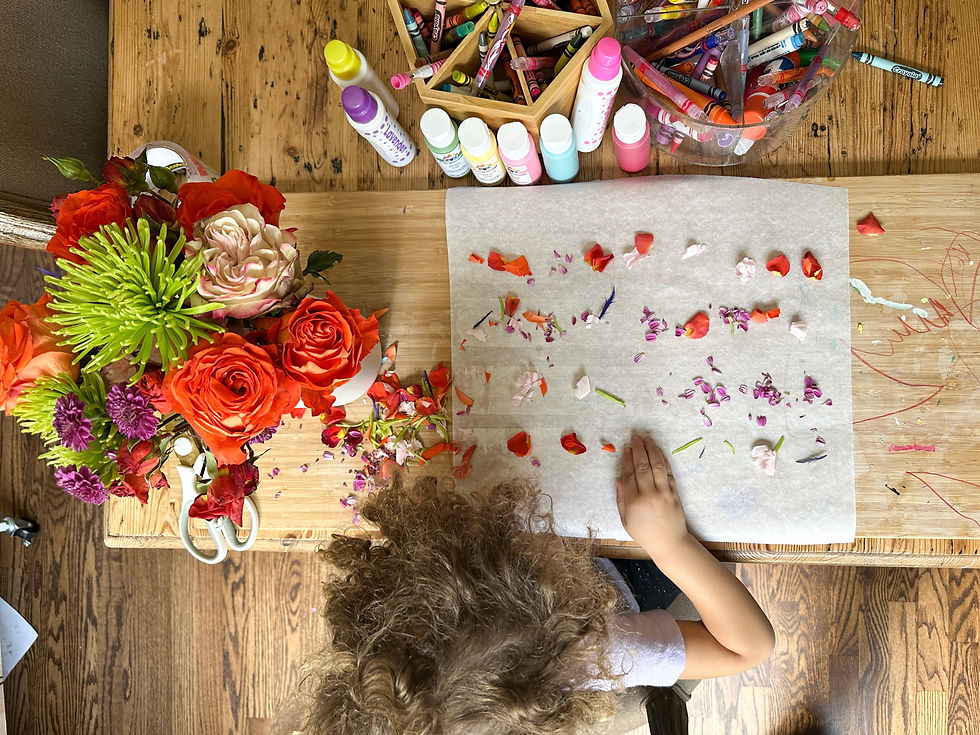 A girl doing a craft with flower petals
