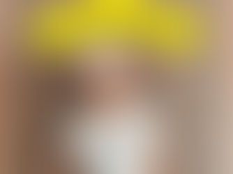 A woman wearing a hat with a Black Friday sign and slatted bachground.