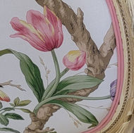 Closeup of the back of a floral chair.