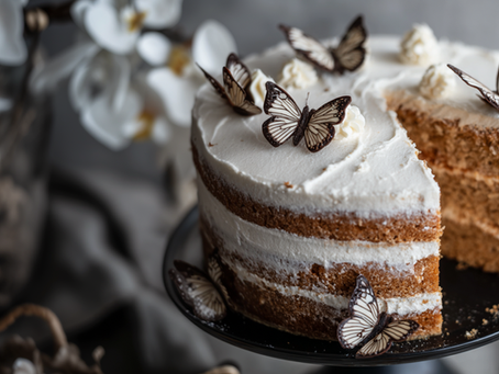 Three-tiered cake with chocolate butterflies on top.