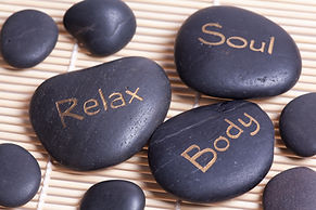 hot black massaging stones on mat.jpg