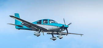 Light blue and white propeller plane flying