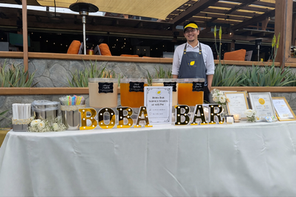 Boba Bar catering setup with staff on a patio