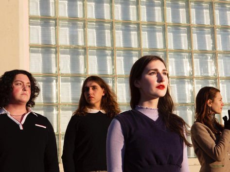 The Opehlias, a folk rock band, looking everywhere but directly into the camera