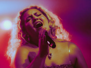 Singer, Molly Grace, performing with soft light around her