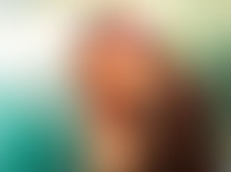 Echosmith vocalist Sydney Sierota performing at The Mint in Los Angeles, singing into a microphone with one hand on her chest in a black top with cream embroidery detail under teal and warm stage lighting