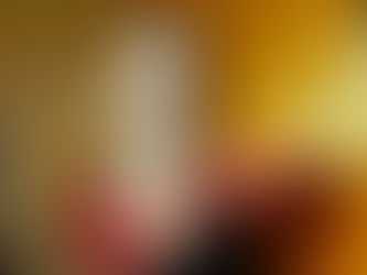 Lilyisthatyou photographed backstage at Elsewhere in Brooklyn, wearing a red lace top and black dress with dramatic makeup and Vivienne Westwood earrings against a warm orange wall