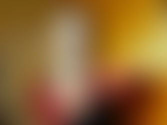 Lilyisthatyou photographed backstage at Elsewhere in Brooklyn, wearing a red lace top and black dress with dramatic makeup and Vivienne Westwood earrings against a warm orange wall