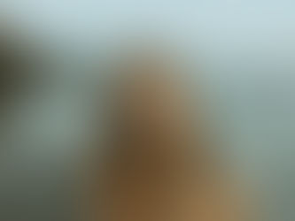 Cinematic Indie Folk singer, Jazmine White, on a beach looking into the camera