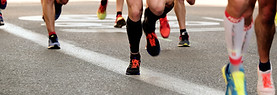 people running on gray asphalt road duri