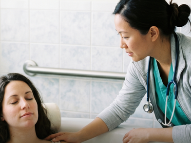 Nurse from Emirates Home Care ( EHC ) taking care of a woman after the delivery at their home in Abu Dhabi.