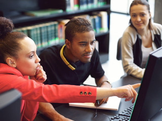 Students looking at Computer