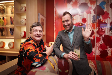 Two guests waving to the camera at a bowling alley Christmas party in London