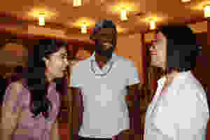 Photo from Ammud.org that shows three people smiling and laughing together. Yehudah is in the center of the image.