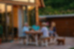 Happy family eating together outdoors. Smiling generation family sitting at dining table d