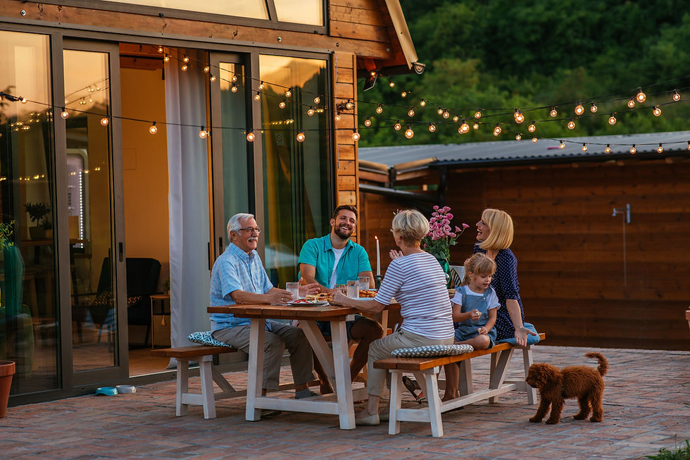 Happy family eating together outdoors. Smiling generation family sitting at dining table d