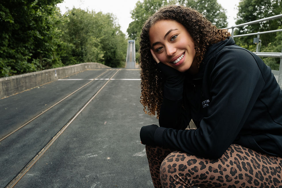 GB athlete sits on the side of a bobsleigh training track