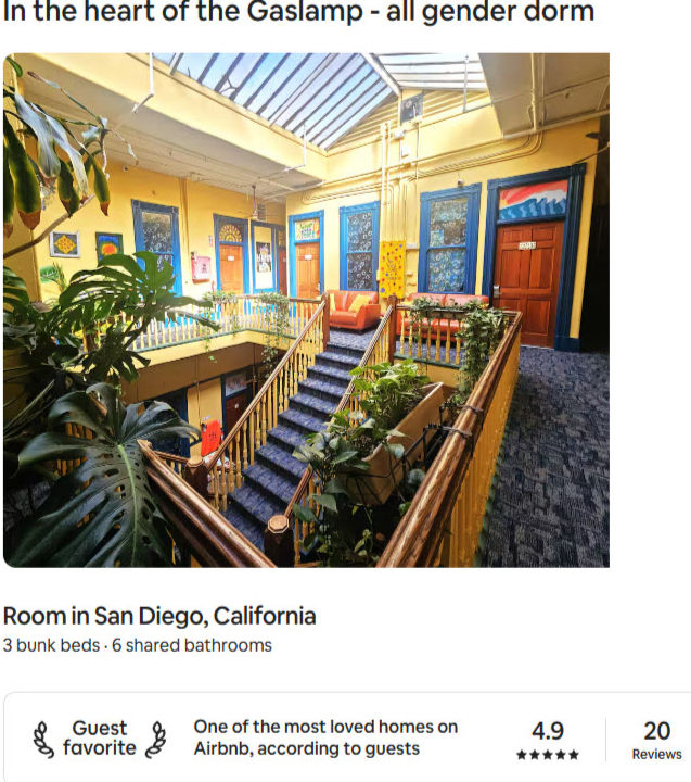 Colorful indoor atrium with plants, wooden railings, and doors. Text: "In the heart of the Gaslamp - all gender dorm." Cozy and vibrant.