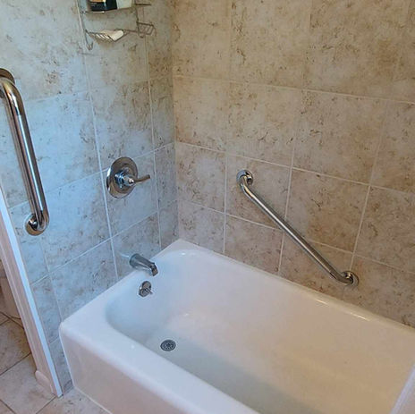 Bathtub with installed grab bars for safer entry and exit, aging-in-place bathroom upgrade by BathQuest