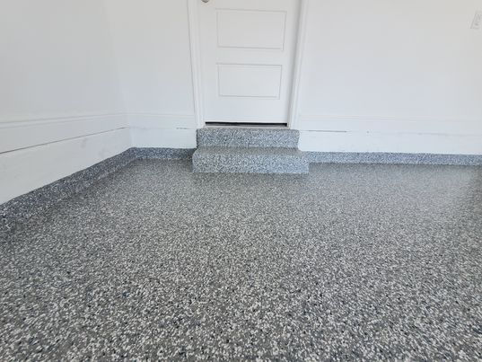 Rocky Mountain epoxy flooring with doorway staircase and cove base