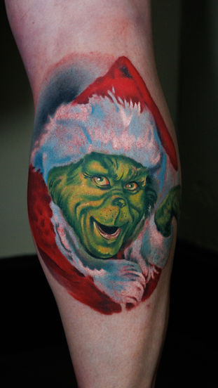 Colour tattoo portrait on a leg, a tribute to the clients mother who always stole Christmas. Made in Llangefni, Isle of Anglesey, North Wales by Shelley Williams.