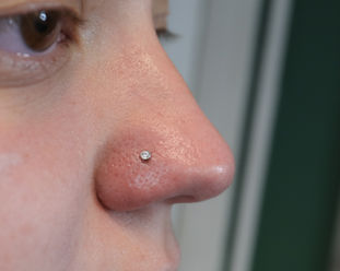 A nose piercing fitted with a low profile gem ball with white CZ from Industrial Strength. Llangefni, Isle of Anglesey, North Wales.