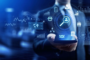 A person holds a phone with many graphics representing workforces, graphs, etc floating above it.