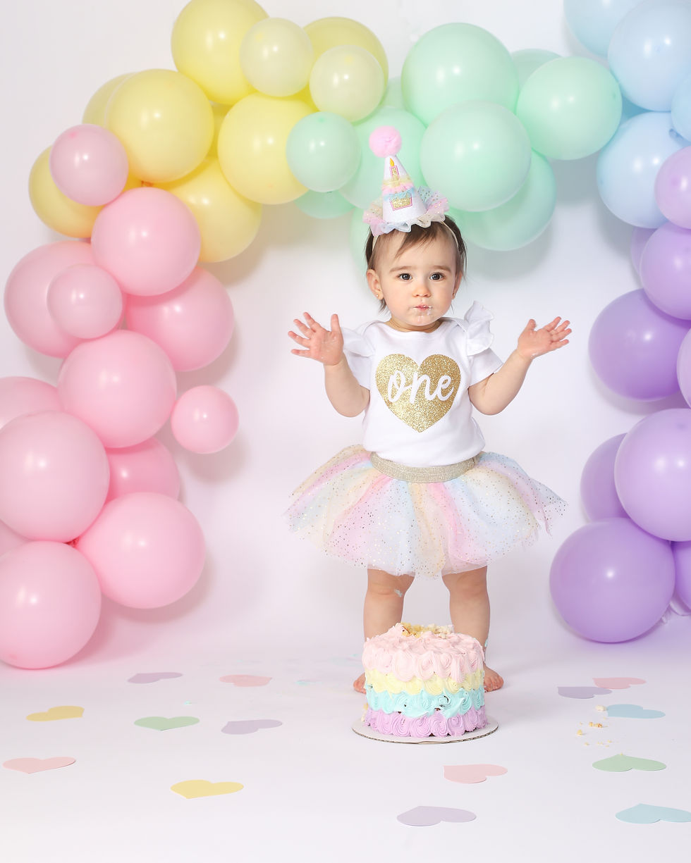 girl in tutu with rainbow colored balloons