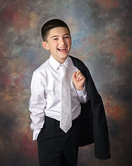 communion boy with suit jacket over shoulder laughing