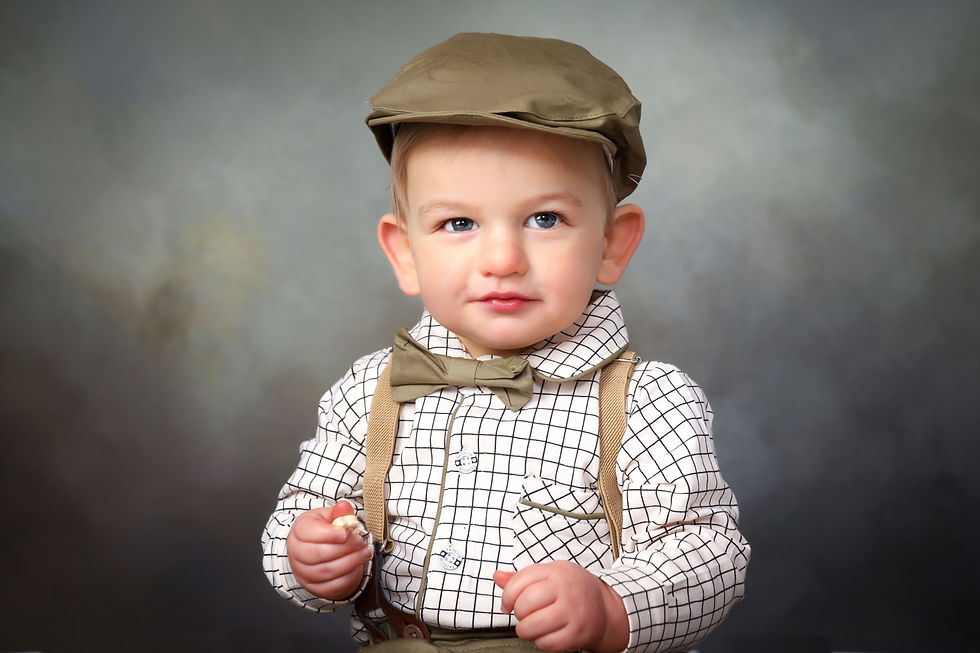 Little boys portrait with cap and suspenders