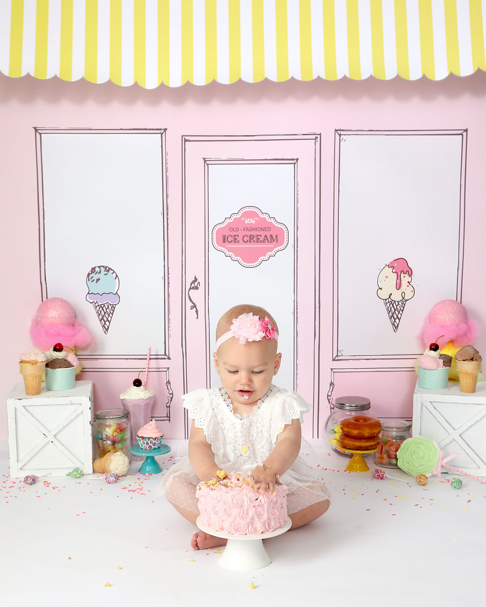 Little girl with birth hands in a cake