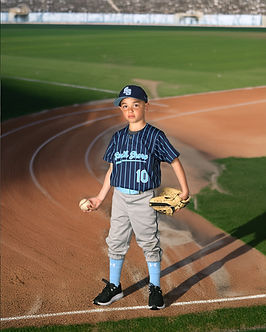 Boy in baseball uniform on a baseball field