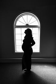 Black and white silhouette of pregnant woman
