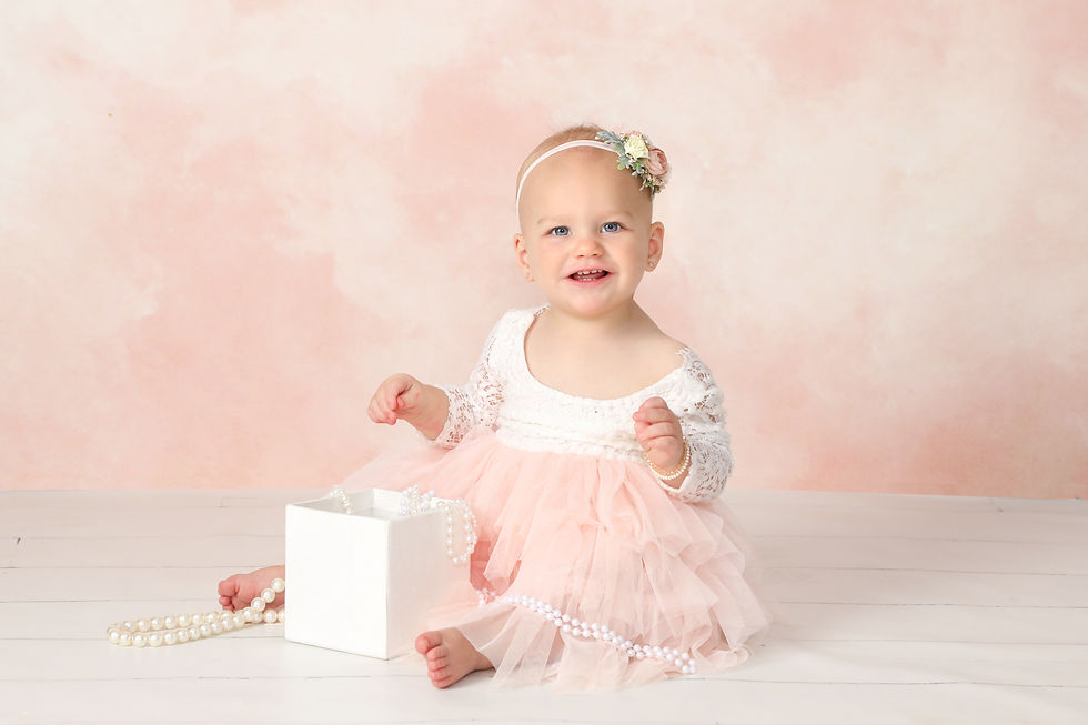 girl in peach and ivory dress with a box of beads
