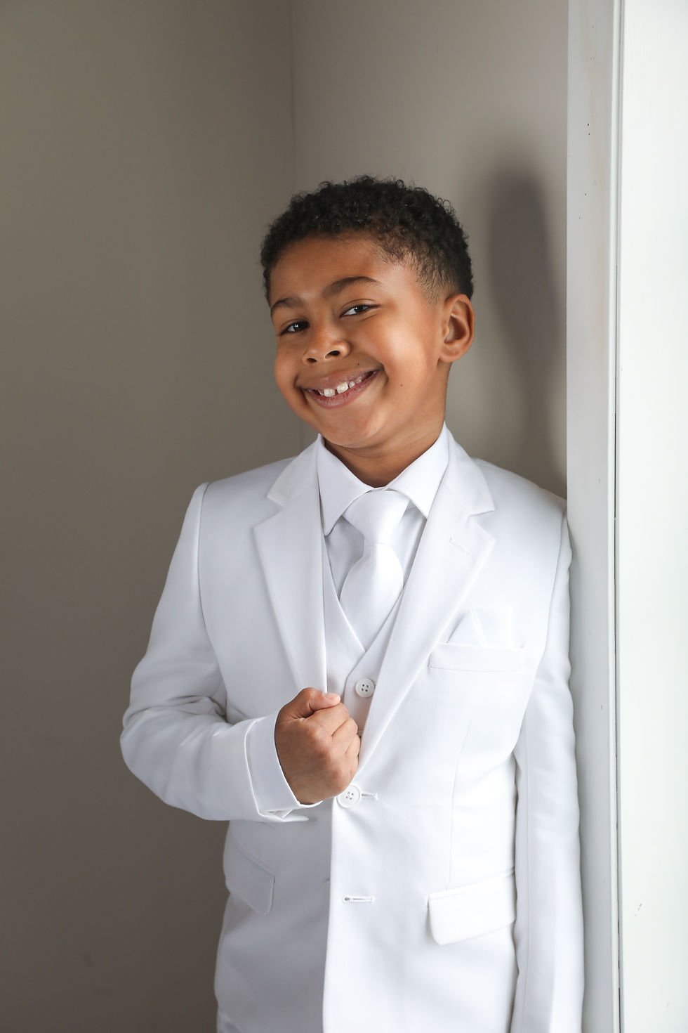 Boy next to window smiling