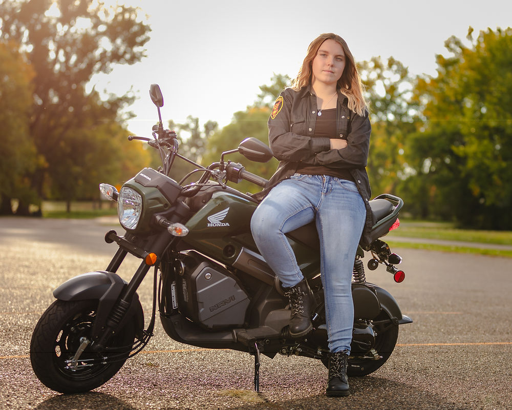 motorcycle with owner sitting on it
