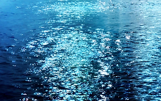 Sparkling blue water with sunlight reflections on the surface