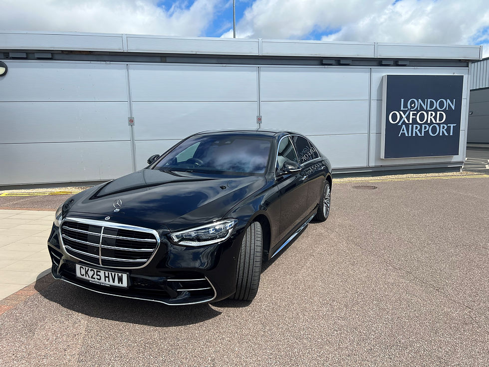 Professional chauffeur greeting client at Oxford Airport arrivals