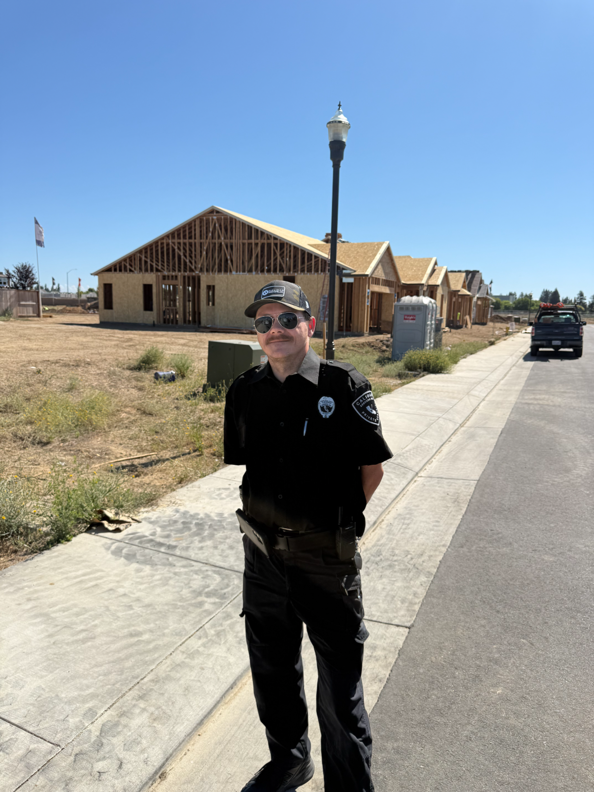 Calidad uniformed security officer posted at a corporate building entrance