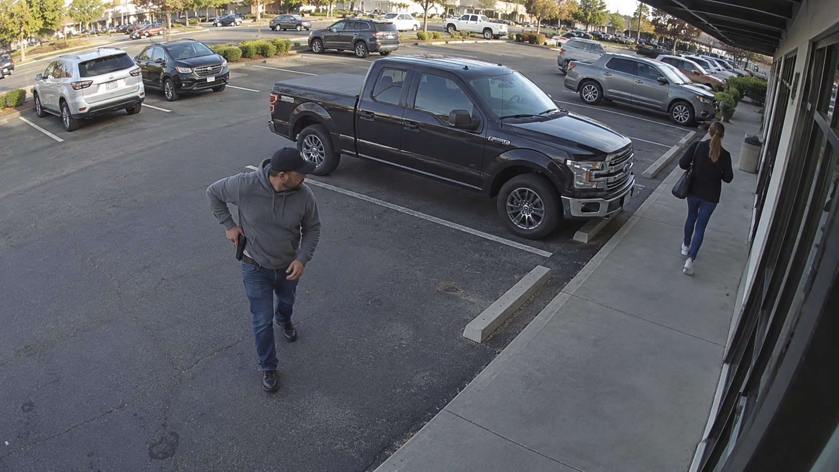 AI detection of an armed man in a storefront parking lot