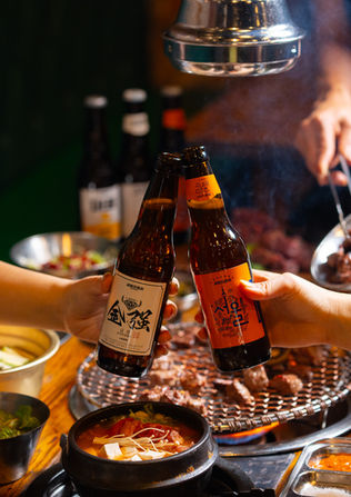 Toasting with Korean beer at a Korean BBQ table