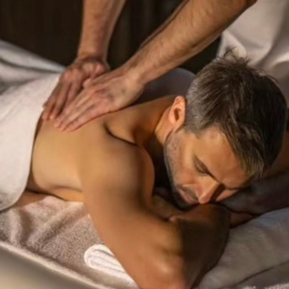 Close-up view of warm hands gently massaging a relaxed shoulder
