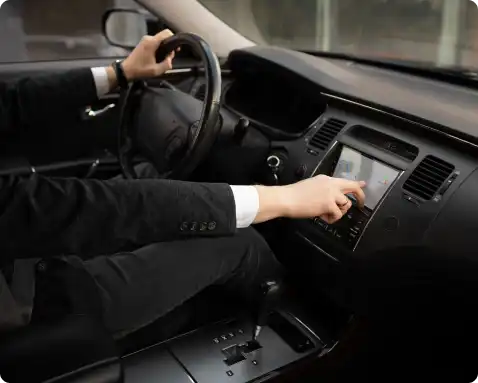 man-using-his-car-s-options-while-driving 1.webp