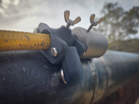 G-Mag magnetic clamp securing a guide tube to ferritic piping during field radiography in the Australian Outback.